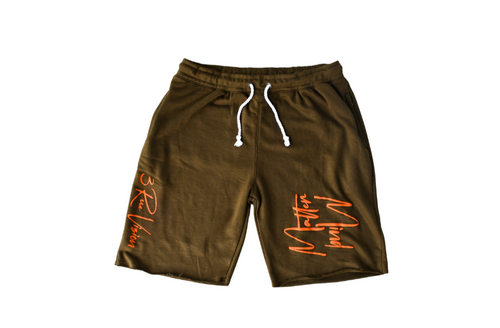 Green shorts with orange text on a white background